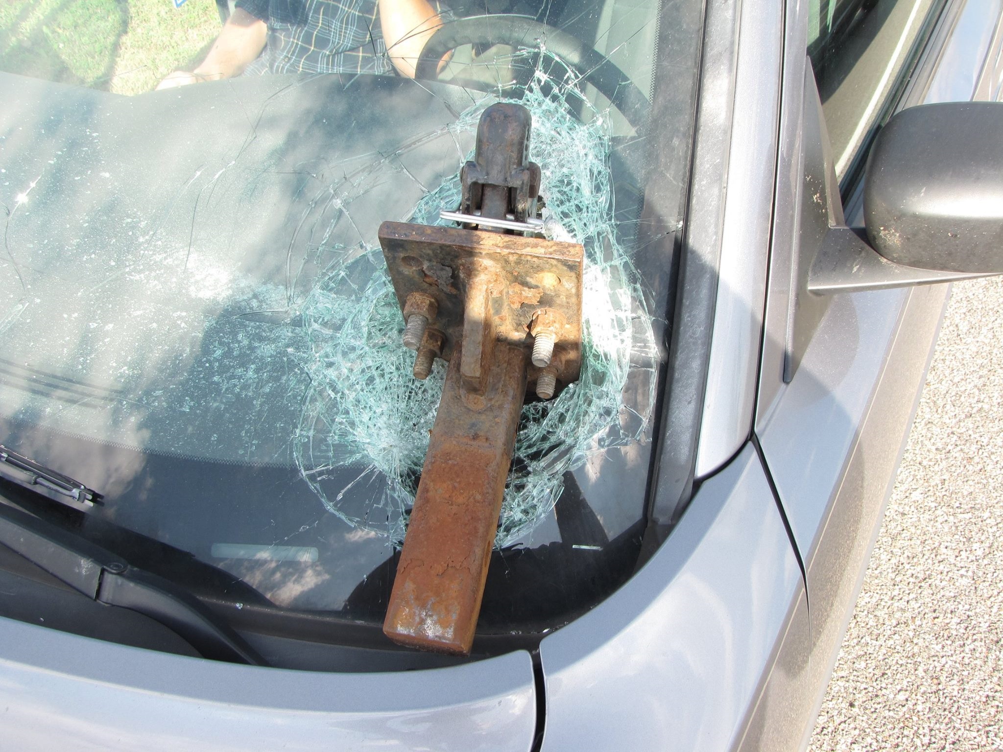 Trailer hitch crashes through windshield on highway